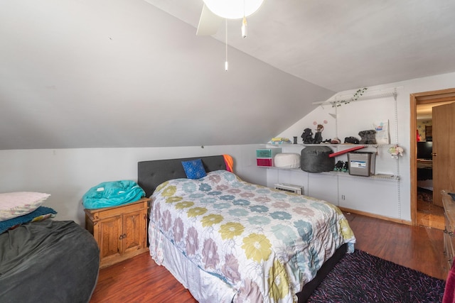 bedroom with lofted ceiling and wood finished floors