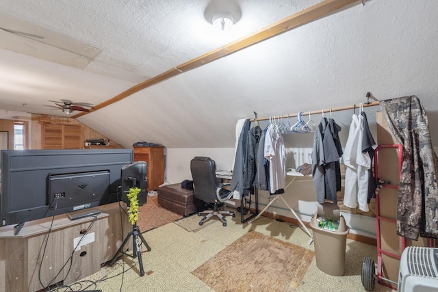 additional living space with lofted ceiling, ceiling fan, and a textured ceiling