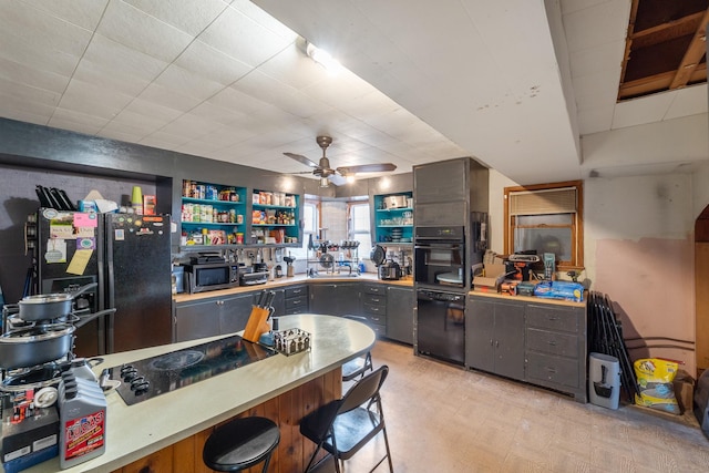 kitchen with stainless steel microwave, freestanding refrigerator, gray cabinets, light floors, and open shelves