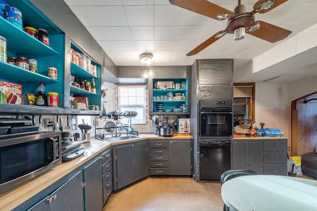 kitchen with open shelves, gray cabinets, ceiling fan, a sink, and black appliances