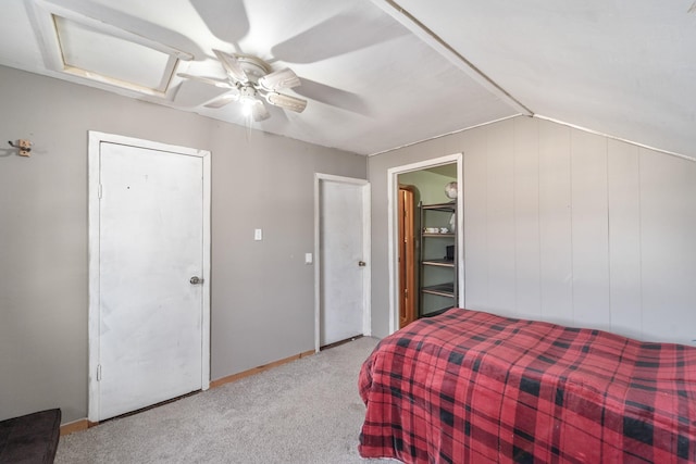 bedroom featuring vaulted ceiling, carpet flooring, attic access, and a ceiling fan