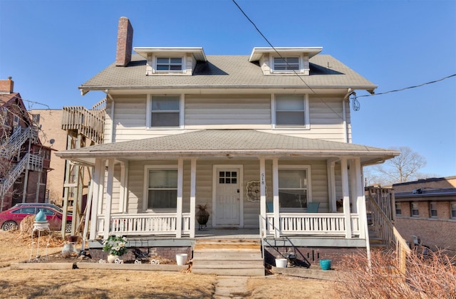 traditional style home with a chimney and a porch