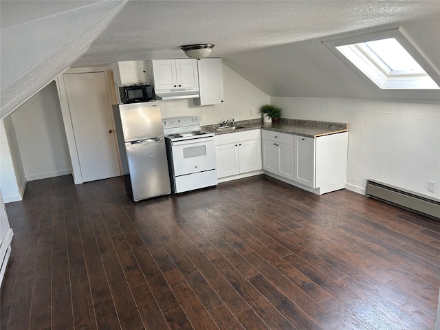 kitchen featuring black microwave, under cabinet range hood, white cabinetry, freestanding refrigerator, and white range with electric stovetop