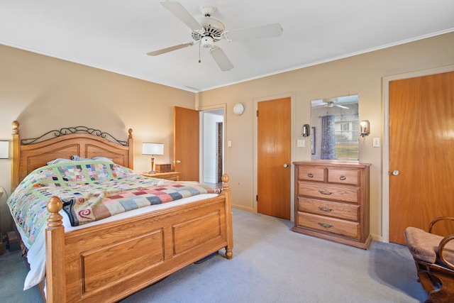 bedroom with light colored carpet, baseboards, crown molding, and ceiling fan