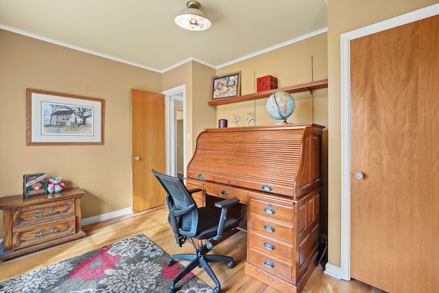 home office featuring baseboards, light wood-style flooring, and crown molding