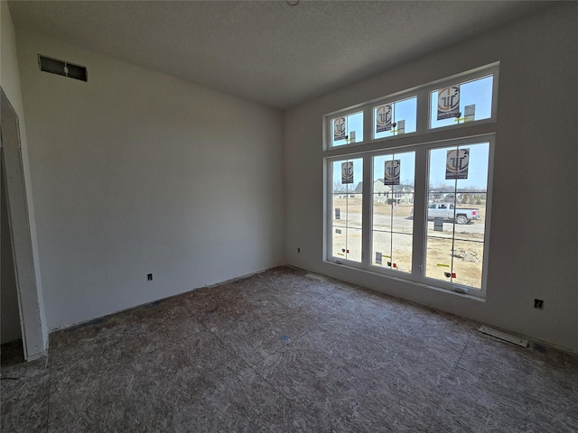 spare room featuring visible vents