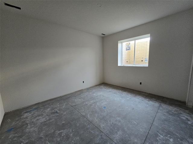 unfurnished room featuring concrete floors