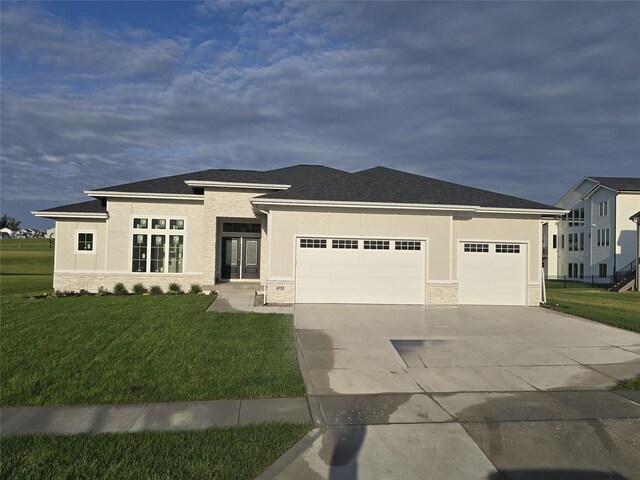 4732 162nd St, Urbandale, IA 50323 - prairie-style home with a garage, driveway, stone siding, and a front lawn