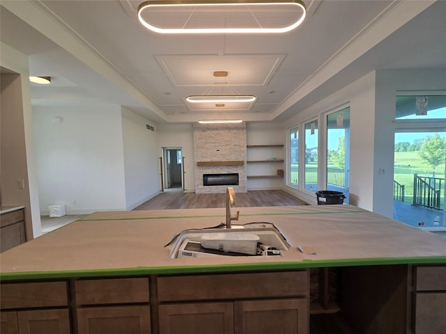 4732 162nd St, Urbandale, IA 50323 - kitchen with a sink, open floor plan, an island with sink, a fireplace, and light countertops