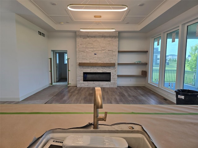4732 162nd St, Urbandale, IA 50323 - living area with wood finished floors, a stone fireplace, and baseboards