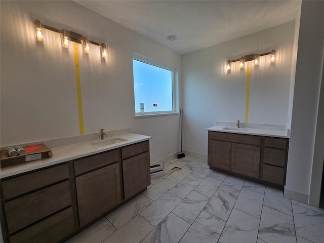 4732 162nd St, Urbandale, IA 50323 - bathroom featuring marble look tiles, vanity, and baseboards