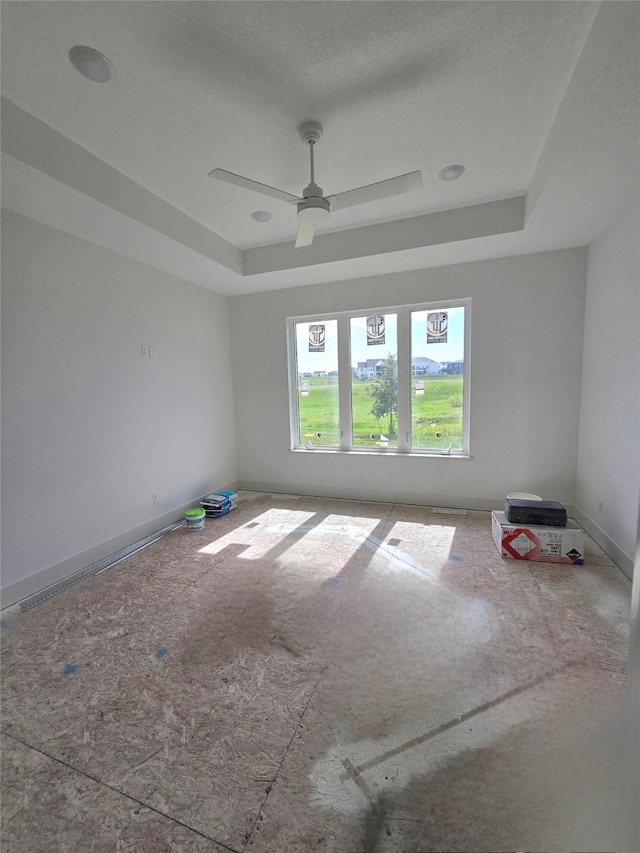 4732 162nd St, Urbandale, IA 50323 - unfurnished room with a tray ceiling and ceiling fan