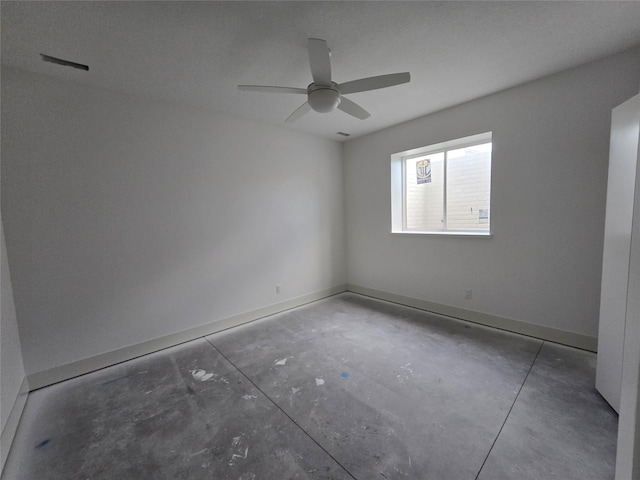 4732 162nd St, Urbandale, IA 50323 - spare room featuring unfinished concrete flooring, a ceiling fan, and baseboards