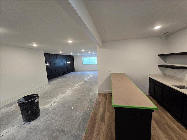 4732 162nd St, Urbandale, IA 50323 - kitchen with open shelves, dark cabinets, recessed lighting, baseboards, and light countertops