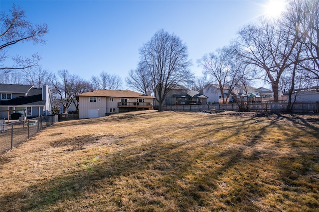 view of yard featuring a fenced backyard and a residential view