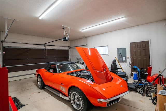 garage featuring electric panel and a garage door opener