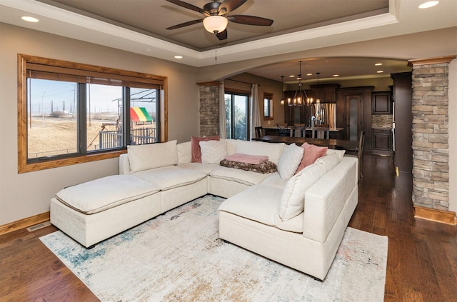 14201 Brookview Dr, Urbandale, IA 50323 - living room with a raised ceiling, a chandelier, arched walkways, recessed lighting, and ceiling fan