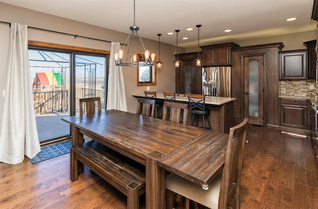 14201 Brookview Dr, Urbandale, IA 50323 - dining area with dark wood finished floors, a chandelier, and recessed lighting