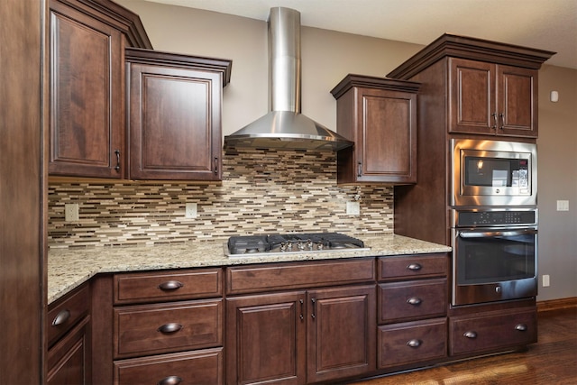 14201 Brookview Dr, Urbandale, IA 50323 - kitchen featuring appliances with stainless steel finishes, wall chimney range hood, dark wood-style flooring, decorative backsplash, and dark brown cabinets
