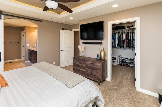 14201 Brookview Dr, Urbandale, IA 50323 - bedroom featuring arched walkways, a walk in closet, light colored carpet, a closet, and recessed lighting