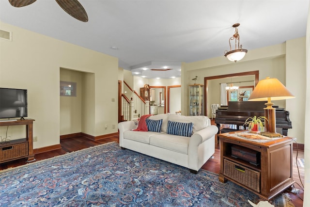 1905 W Olive St, Marshalltown, IA 50158 - living area with wood finished floors, stairway, a chandelier, and baseboards