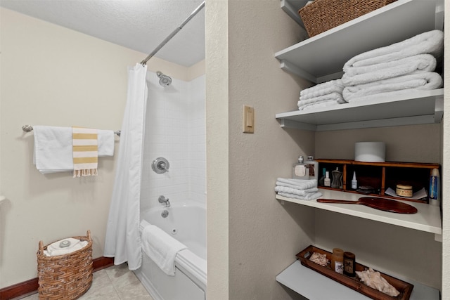 1905 W Olive St, Marshalltown, IA 50158 - bathroom featuring shower / bath combination with curtain, tile patterned flooring, and baseboards