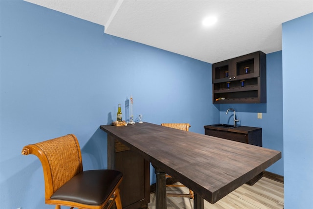 1905 W Olive St, Marshalltown, IA 50158 - bar area featuring a sink, wood finished floors, and baseboards