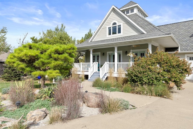 view of front of property featuring covered porch and roof with shingles