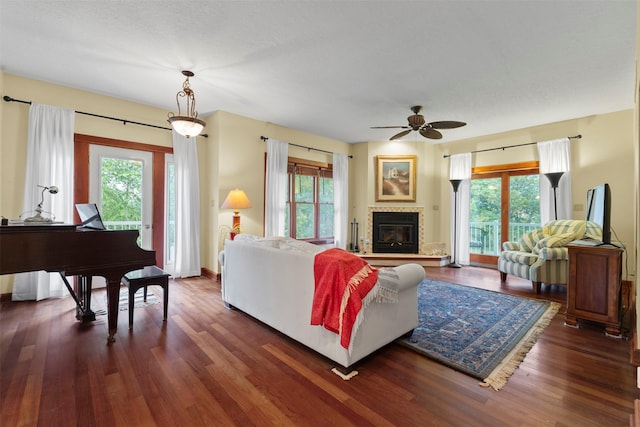 1905 W Olive St, Marshalltown, IA 50158 - living room featuring healthy amount of natural light, dark wood-style flooring, and ceiling fan