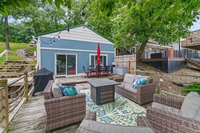 rear view of property featuring an outdoor hangout area, stairway, a deck, and outdoor dining space