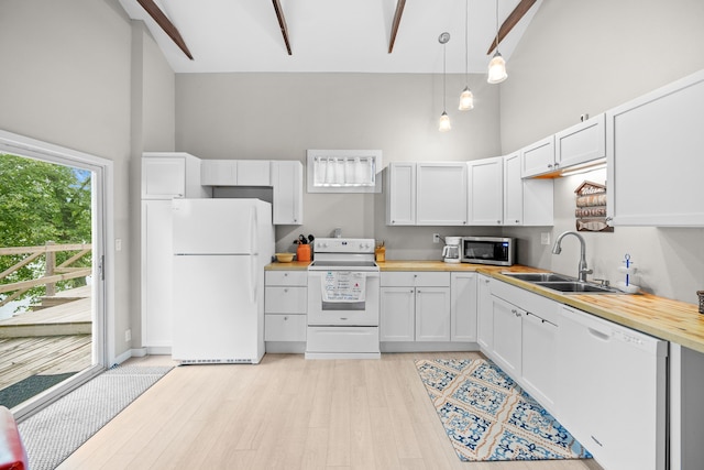 kitchen featuring high vaulted ceiling, light wood-style flooring, white appliances, a sink, and pendant lighting