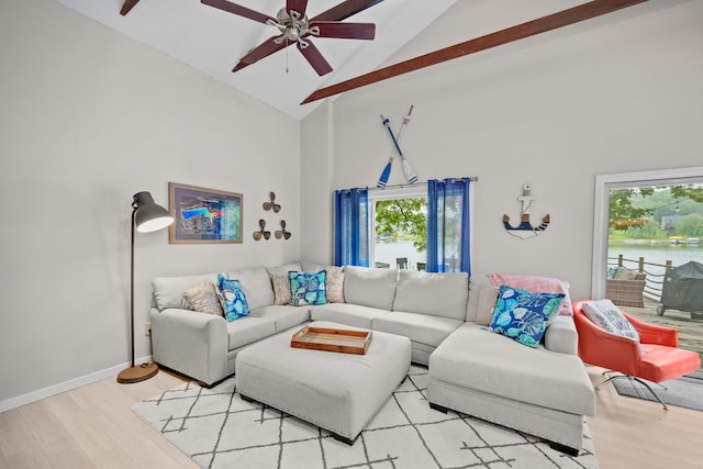 living area featuring baseboards, ceiling fan, high vaulted ceiling, and wood finished floors