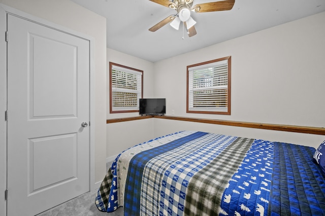 bedroom with carpet floors, multiple windows, and a ceiling fan