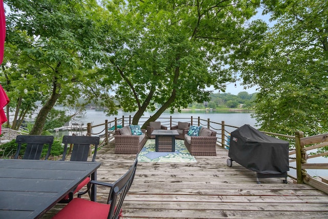 deck featuring a water view and outdoor lounge area