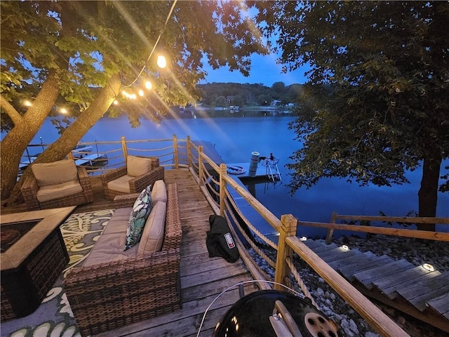 view of dock featuring outdoor lounge area and a water view