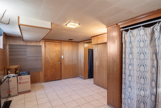 finished basement featuring wood walls