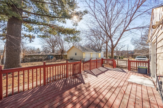 wooden deck with a fenced backyard and an outdoor structure