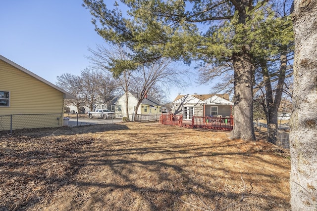 view of yard with a deck and fence