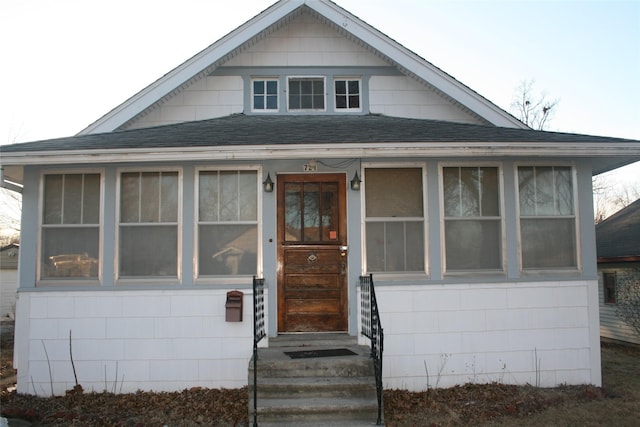 bungalow-style house with roof with shingles