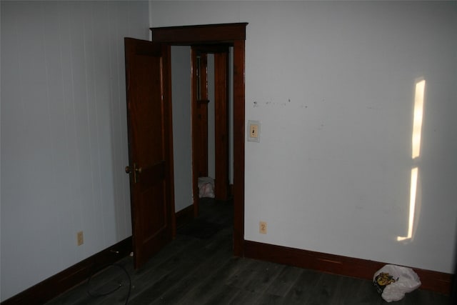 unfurnished room featuring dark wood finished floors and baseboards