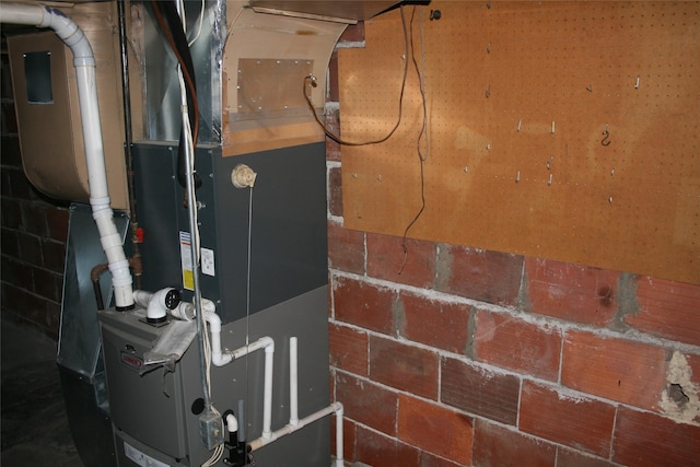 utility room featuring heating unit