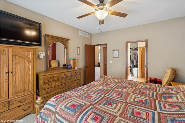 bedroom with ceiling fan, visible vents, and light colored carpet