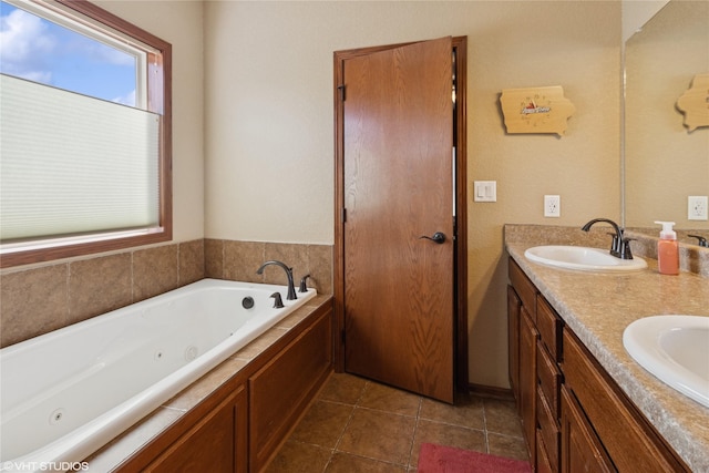 bathroom with double vanity, a sink, a tub with jets, and tile patterned floors