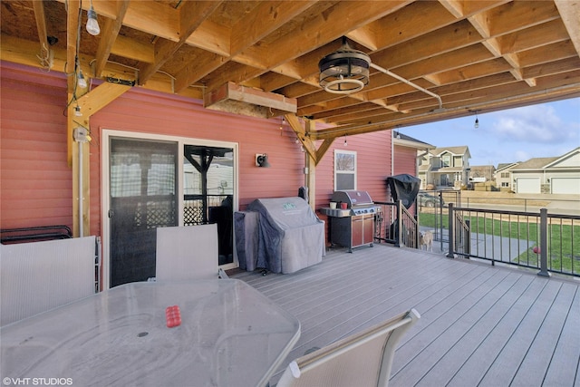 deck featuring outdoor dining area, grilling area, and a residential view