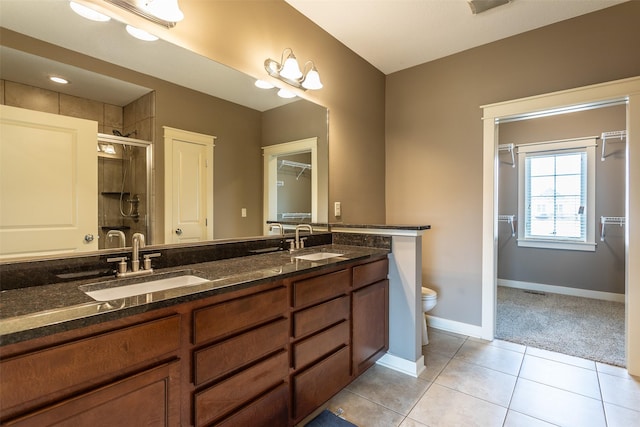 bathroom with toilet, tile patterned flooring, a sink, and a shower stall