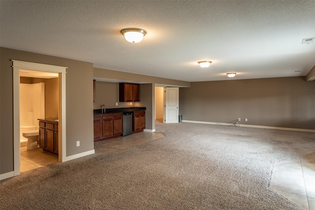 unfurnished living room with visible vents, light carpet, a sink, a textured ceiling, and baseboards