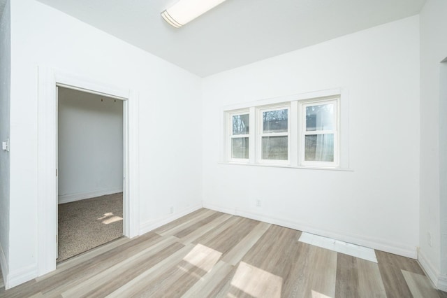 empty room featuring baseboards and wood finished floors