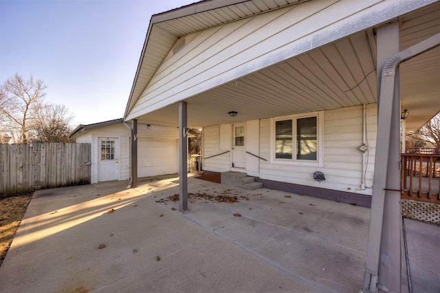 view of patio / terrace with a garage and fence