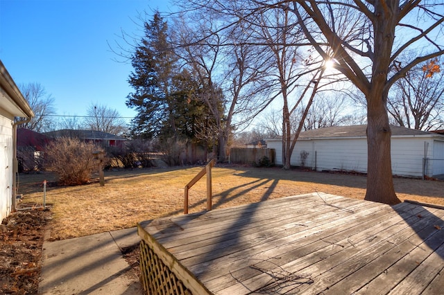 wooden terrace with fence and a lawn