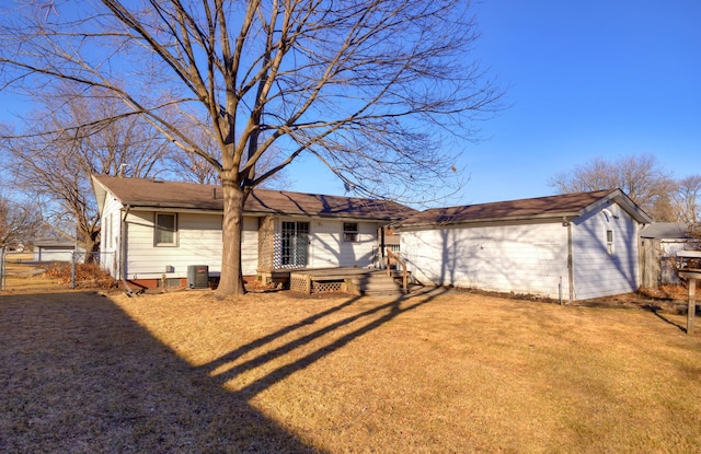 back of house featuring a yard, central AC unit, a wooden deck, and fence